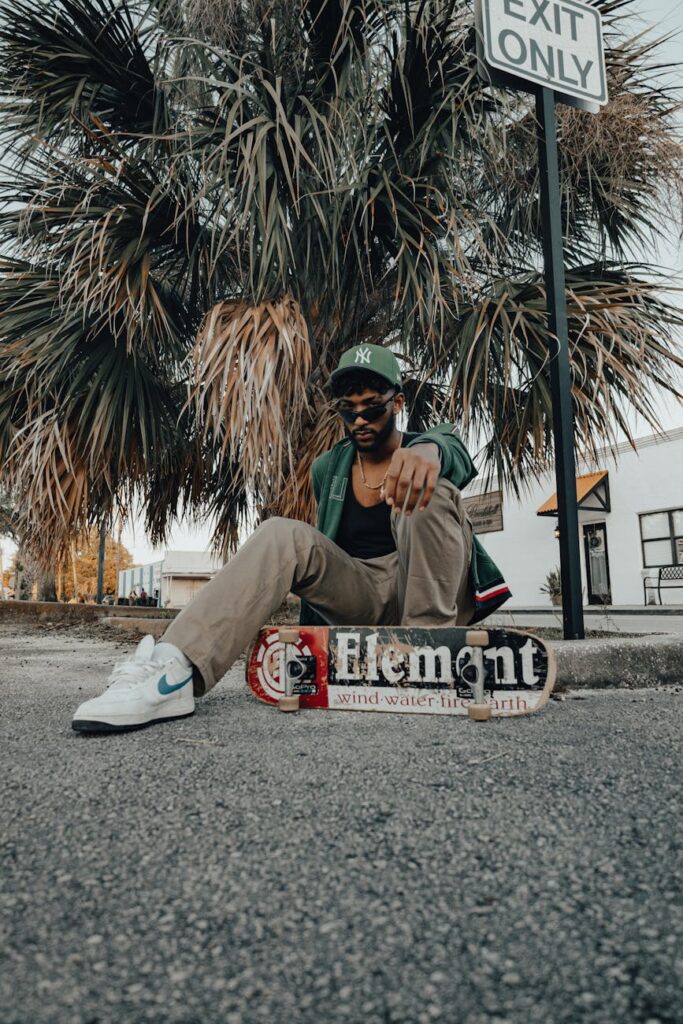 What Color Shoes to Wear With Mint Green Dress? Try Metallic for a Chic Look a man sitting on the ground with a skateboard